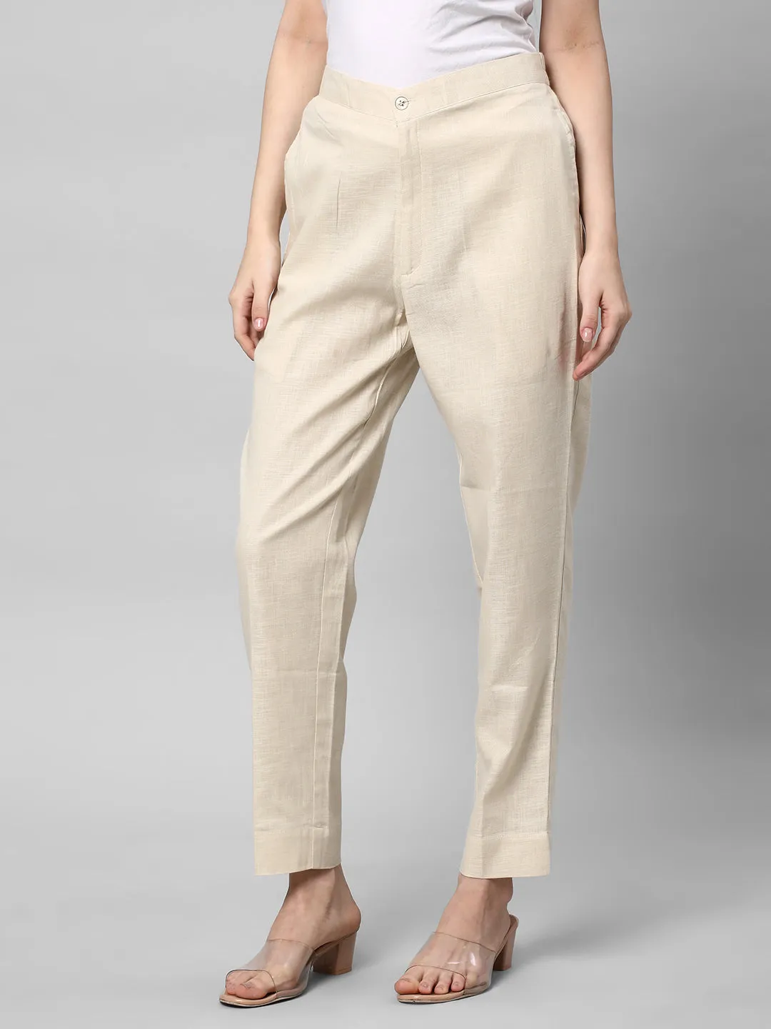 A Cream ankle length cotton linen pant with plain belt in front.