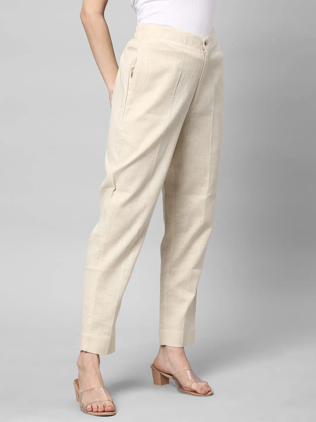 A Cream ankle length cotton linen pant with plain belt in front.